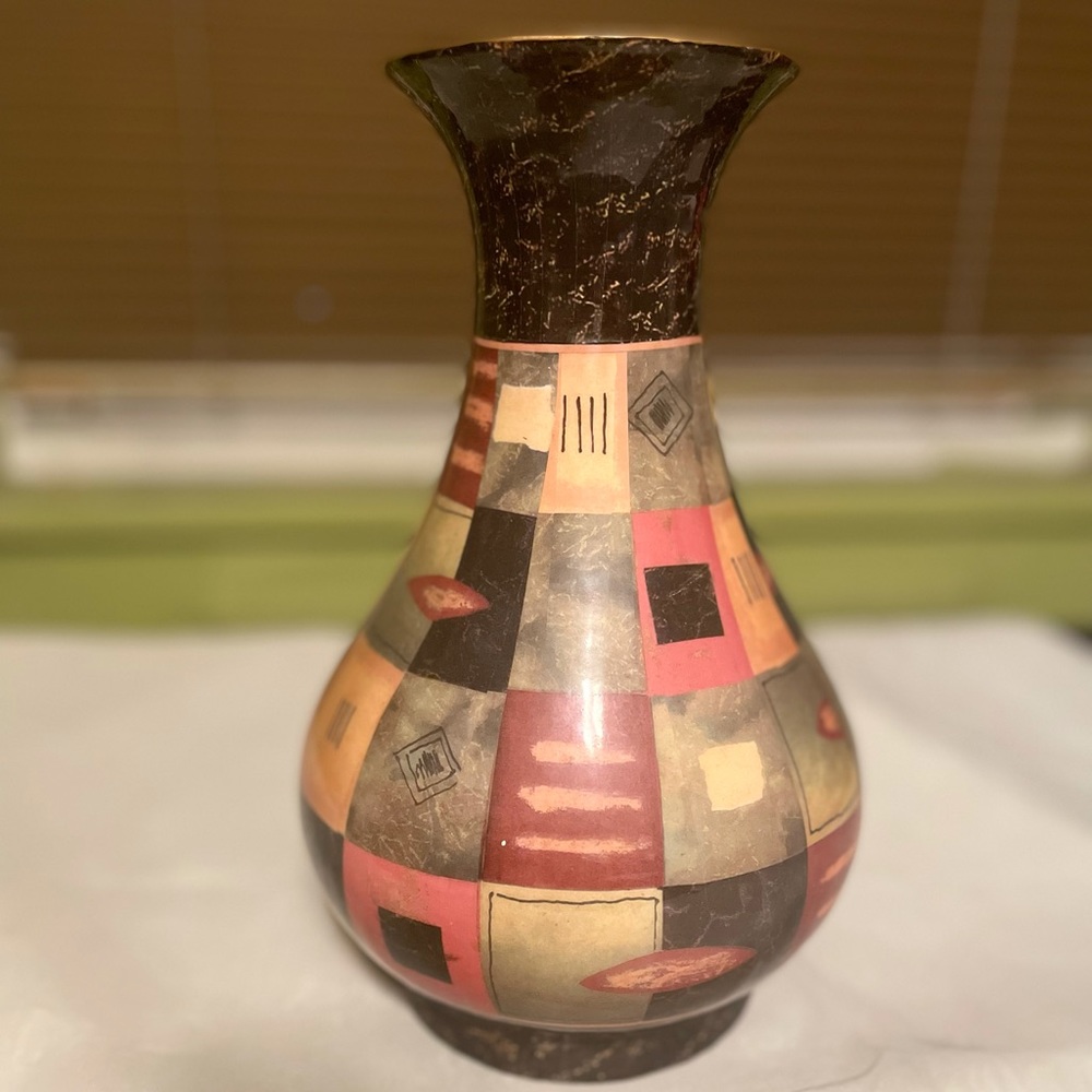 Beautiful vase orange, black, olive , reddish wine and mustard colors.